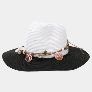 Detail of straw sun hat featuring a natural shell band and contrast color design