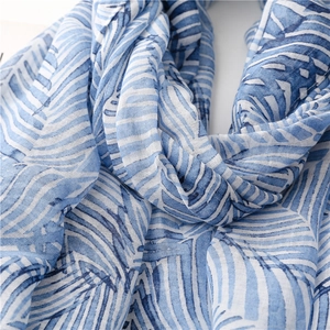 Close-up of the blue and white leaf pattern and tassels on the soft bohemian beach shawl