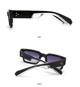 Detail view of black square sunglasses with gradient purple lenses and golden star studs