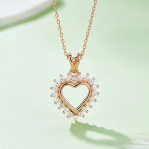 Elegant rose gold S925 silver heart necklace with pave-set moissanite on a green surface