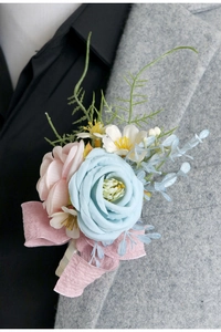 Detail of rose boutonniere with blue and pink flowers pinned on a grey suit lapel