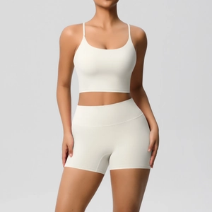 Close-up of white high-waisted fitness shorts and sports bra in breathable matte fabric