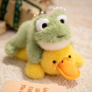 Cute plush stuffed green frog and yellow duck dolls lying on a soft cozy carpet
