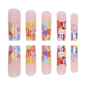 Long coffin-shaped press-on nails featuring colorful cartoon graffiti and floral patterns