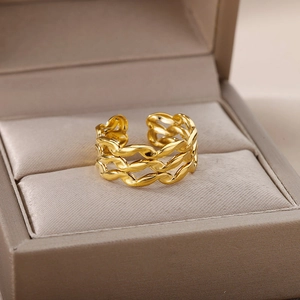 Close-up of a 18k gold plated braided chain ring displayed on a soft satin fabric