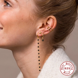 Elegant S925 sterling silver four-leaf clover drop earrings with crystal accents on model