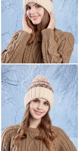 Close-up of beige knit beanie with jacquard patterns and pompom on textured sweater