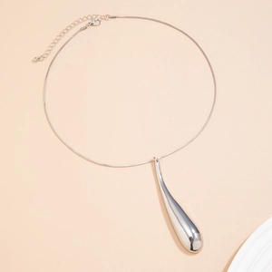 Detailed view of a silver water drop pendant on a sleek snake chain with lobster clasp