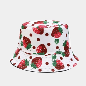 Detail of white cotton bucket hat with strawberry print and stitched brim for sun protection