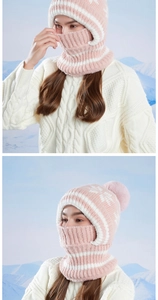 Close-up of pink knit winter hat with thick fleece lining and warm faux fur pompom detail