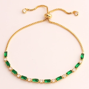 Adjustable gold bracelet with emerald-cut green stones and round cubic zirconia detail