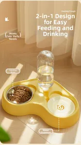 Detail view of yellow pet feeder with stainless bowl and automatic water bottle