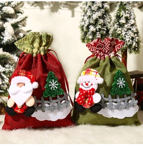 Detailed view of drawstring Christmas gift bags with Santa and Snowman 3D plush designs