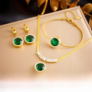 Detail of emerald green jewelry set with snake chain necklace and halo crystals