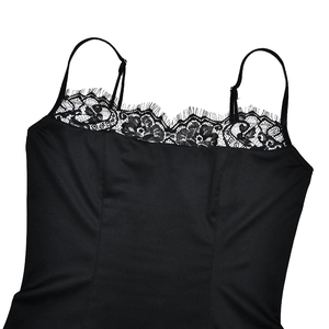 Detail of black satin camisole with delicate lace trim neckline and slender straps