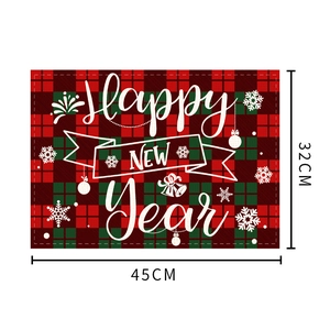 Detail of red and green plaid Christmas placemat with Happy New Year text and dimensions