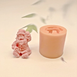 Detailed pink silicone mold and finished 3D sitting Santa Claus wax candle figure