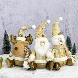 Golden Christmas plush set with Santa Claus, Snowman, and Reindeer figurines on snow