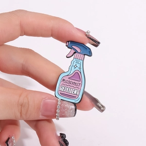 Pink spray bottle enamel pin with Misogynist Repellent text and blue accents