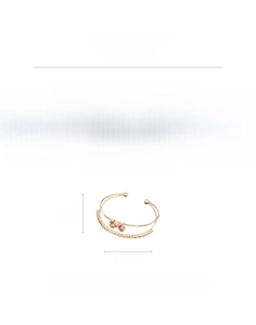 Detail view of pink zircon bow bracelet in gold plated copper measuring 6cm by 5.5cm