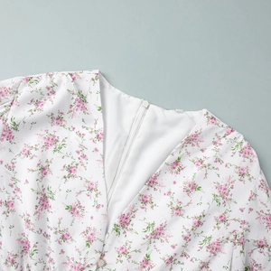 Detail of V-neckline on floral print dress featuring a smooth hidden zipper closure