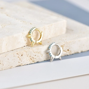 Punk style hoop earrings with turquoise stones and spikes in gold and silver finish