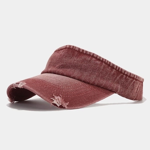 Close-up of distressed denim sun visor featuring frayed edges and vintage washed finish