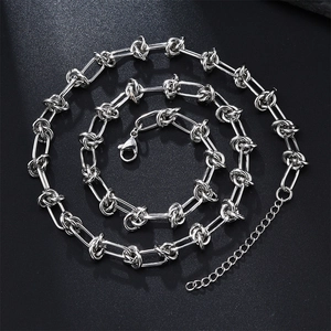 Minimalist silver stainless steel foot bell necklace with stylish knot-shaped chain links