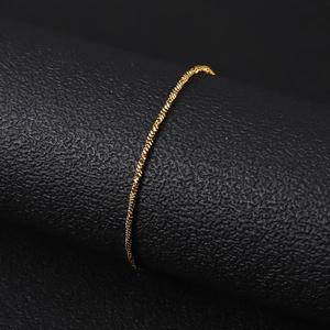 Macro shot of 18K gold plated stainless steel twisted rope chain on black leather