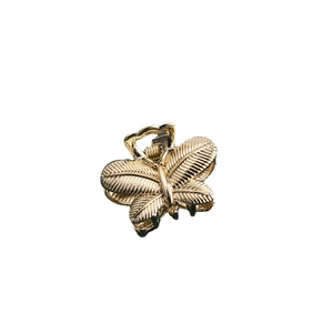 Detail of a vintage golden butterfly hair claw clip with delicate vein textured wings
