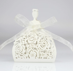 Detail of white laser-cut wedding candy box with elegant translucent ribbon bow