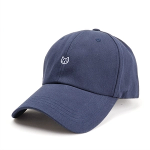 Close-up of white embroidered cat motif on navy blue cotton baseball cap detail