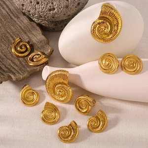 18k gold plated conch and shell earrings with matching ring on aesthetic natural background