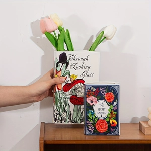 Detail of book-shaped ceramic vases featuring Alice in Wonderland and Secret Garden designs
