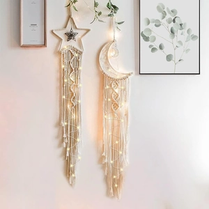 Detail of star and moon woven cotton tapestries with glowing warm LED fairy lights