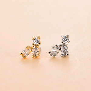 Macro view of gold and silver animal-shaped nose studs with shimmering white cubic zirconia