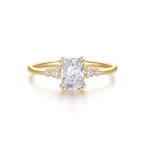 Detailed close-up of S925 sterling silver stamp on golden emerald-cut ring band