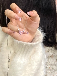 Detailed view of pink heart-shaped crystal pendant on a delicate silver necklace chain