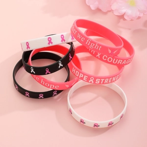 Detail of pink breast cancer awareness silicone wristbands with Hope and Strength text
