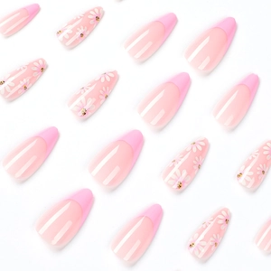 Pink French press-on nails with white daisy patterns and medium long coffin shape