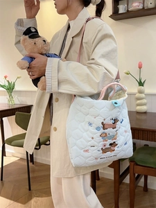 Quilted light blue tote bag with dachshund embroidery and pink handles for daily use