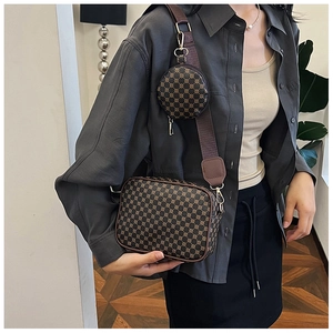 Detail of vintage two-in-one crossbody bag with round pouch and patterned synthetic leather