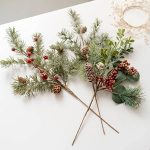 Artificial Christmas pine branch with pine cones, red berries and festive bells decor