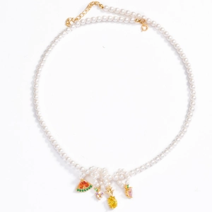 Detail of pearl necklace with colorful gemstone fruit charms like pineapple and grape