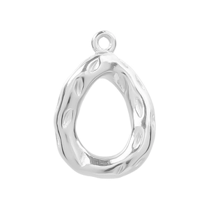 Macro detail of silver teardrop pendant with irregular hammered texture and hanging loop