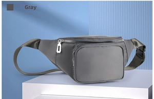 Close-up of grey waterproof nylon waist bag with silver metallic zippers and side buckle strap