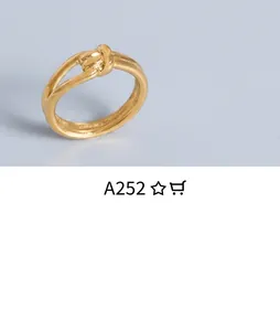 Macro shot of a twisted knot ring in 18k gold finish with a minimalist metal design