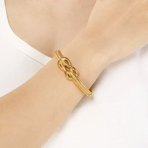 Chic knotted gold cuff bracelet for women featuring an irregular open rope design