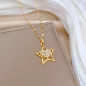Gold star and crystal heart pendant necklace in titanium steel on silk background