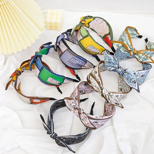 Set of seven colorful floral and geometric print knot headbands in various stylish patterns